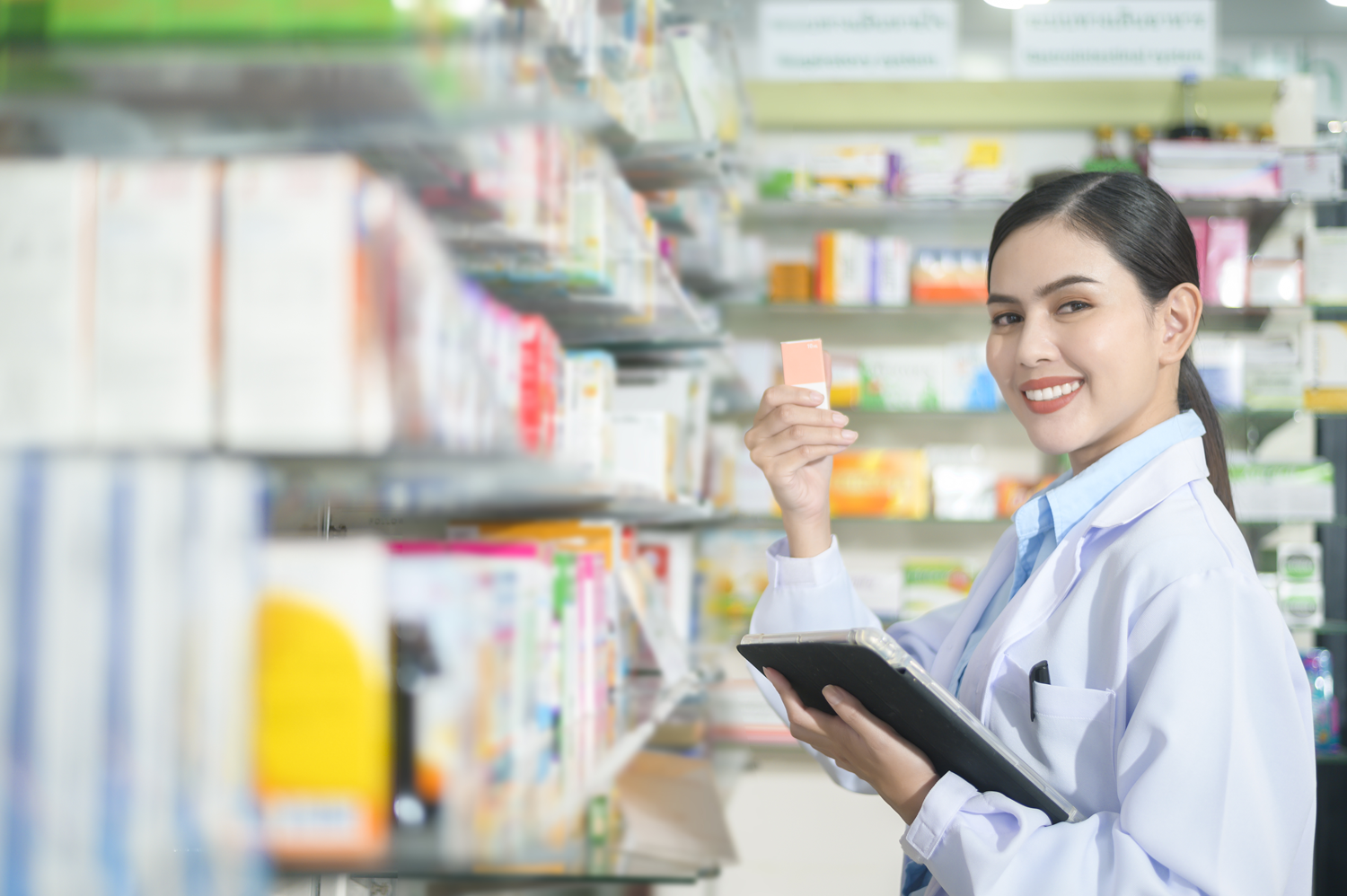 Pharmacist using a tablet in a modern pharmacy